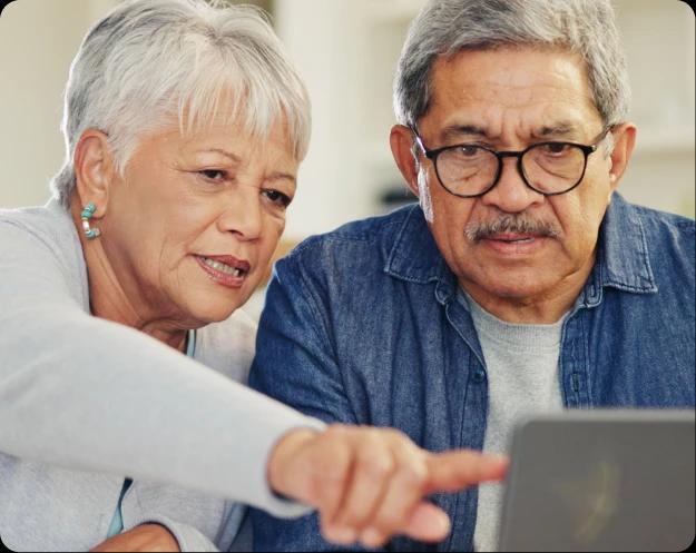 People pointing at laptop screen
