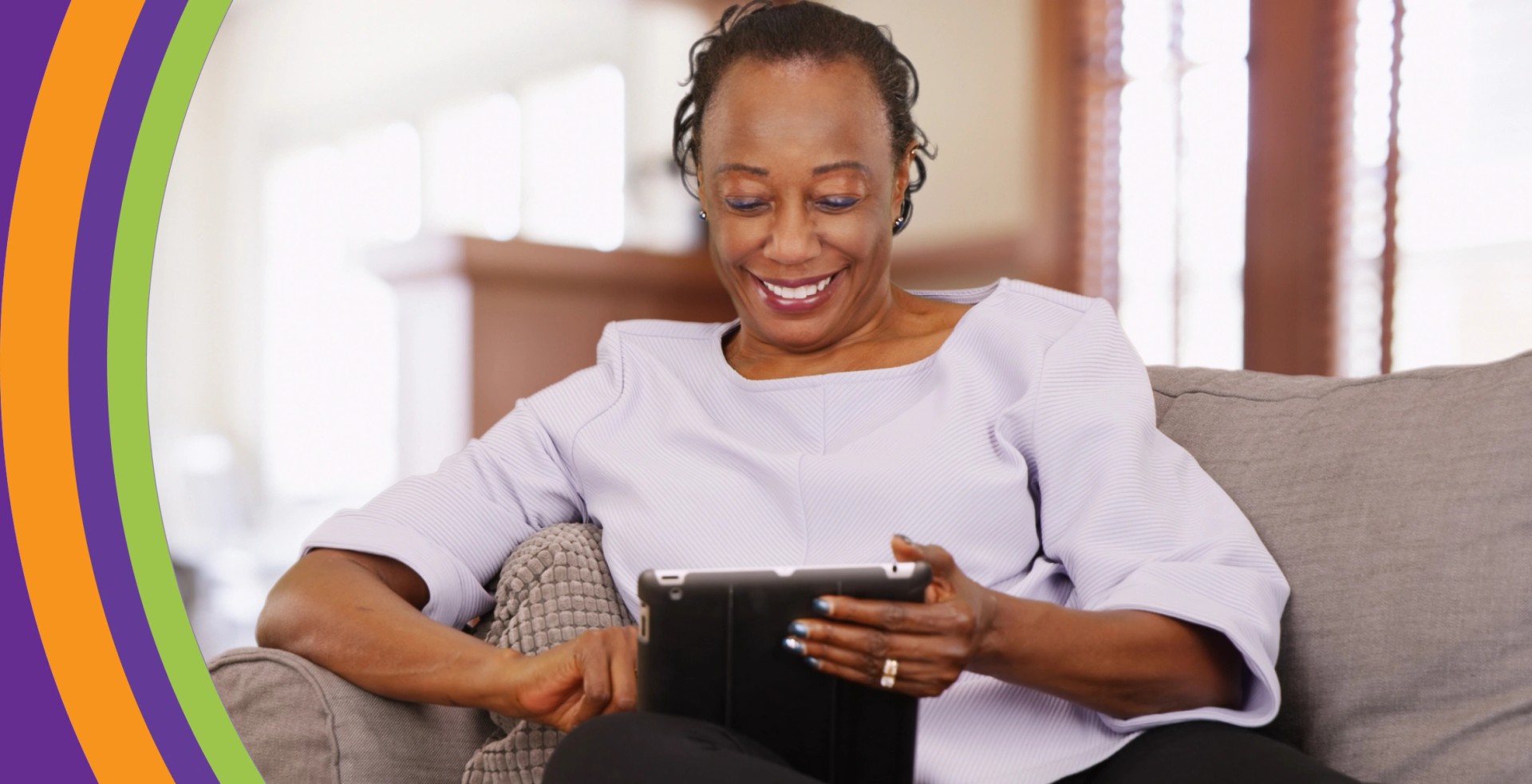 Woman smiling while reading on a tablet